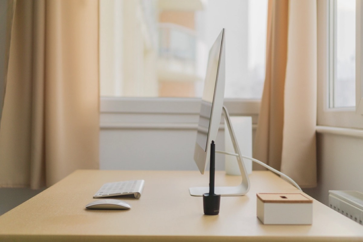 A tidy study desk by a bright window