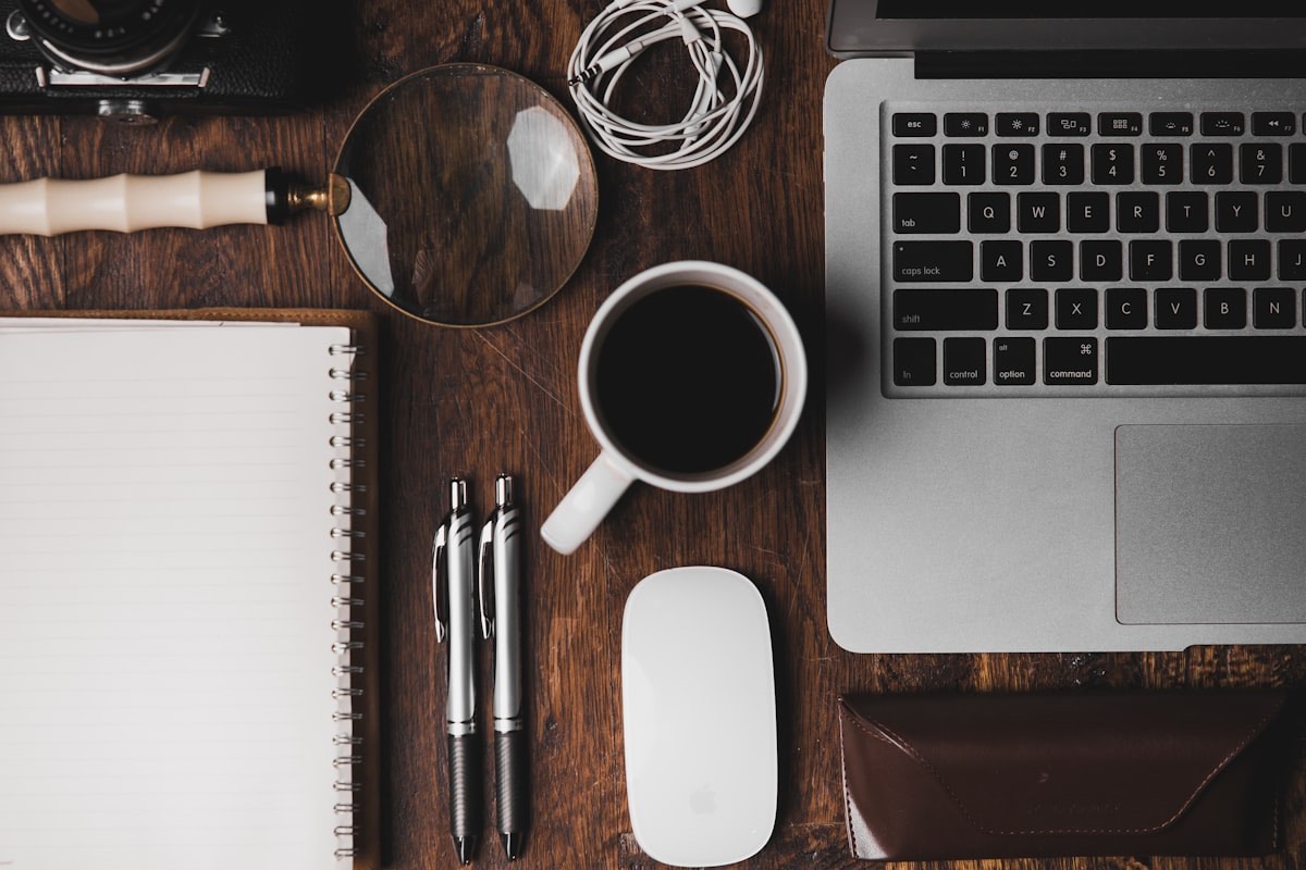 Laptop, notebook and coffee laid out — planning a move to Hatfield as a student